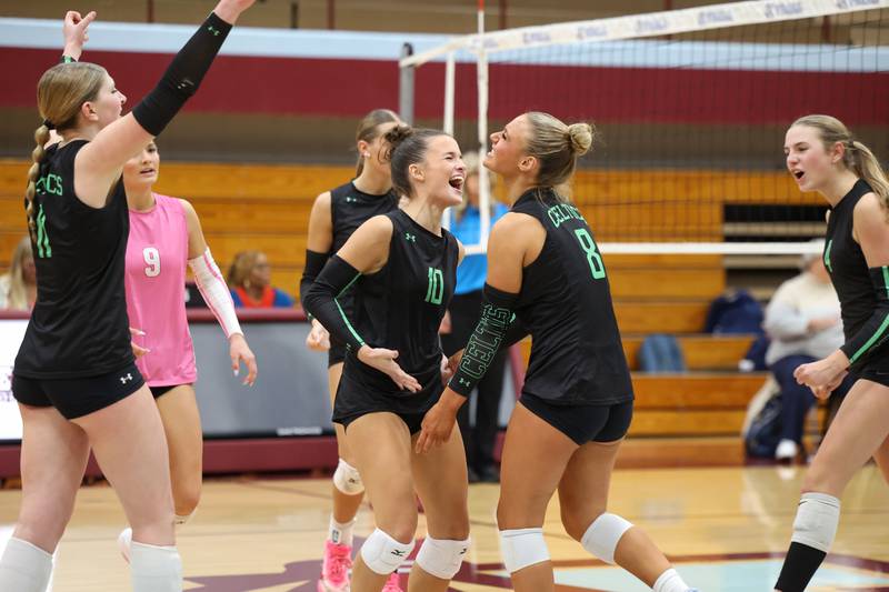Providence's Delaney Purtill (10) and Demi Carbone hug in celebration of a point during Providence's victory in two sets, 25-25, 25-18, over Lemont in the IHSA Class 3A Kankakee Sectional championship on Thursday, Nov. 6, 2025.