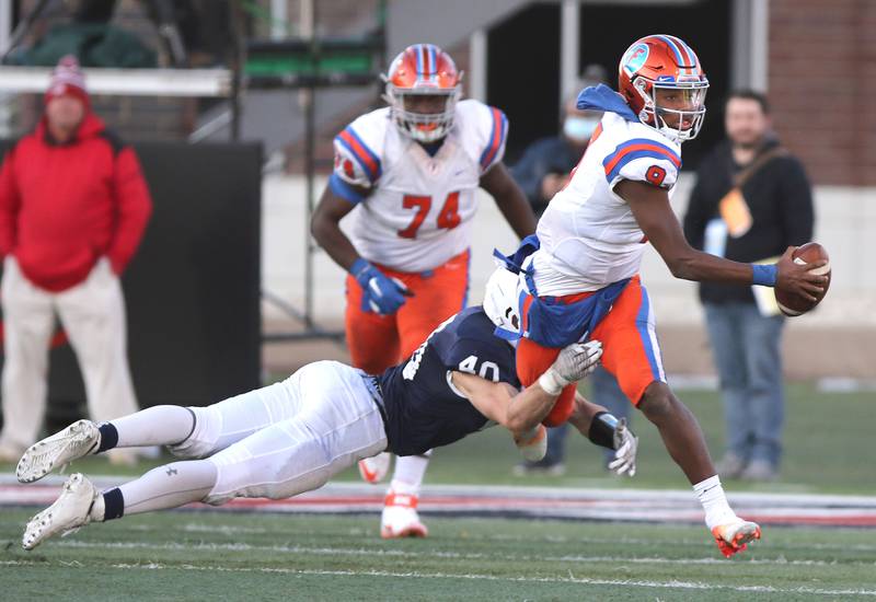 East St. Louis' Robert "Pops" Battle scrambles away from Cary-Grove's Wade Abrams during the Class 6A state championship Saturday, Nov. 27, 2021, in Huskie Stadium at Northern Illinois University in DeKalb.