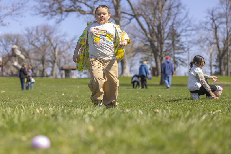 Leo Cardona runs to an egg that he spotted during the Easter egg hunt on April 12, 2025 at Centennial Park in Peru.