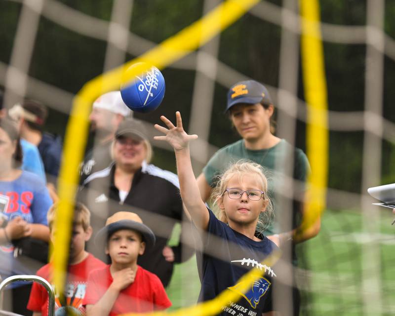 Elin Carlson, 7, of Downers Grove tries to get points in different areas of a net that was set up during the NFL Youth Flag Football Combine Day held at Doerhoefer Park in Downers Grove on Sunday Aug. 6, 2023.