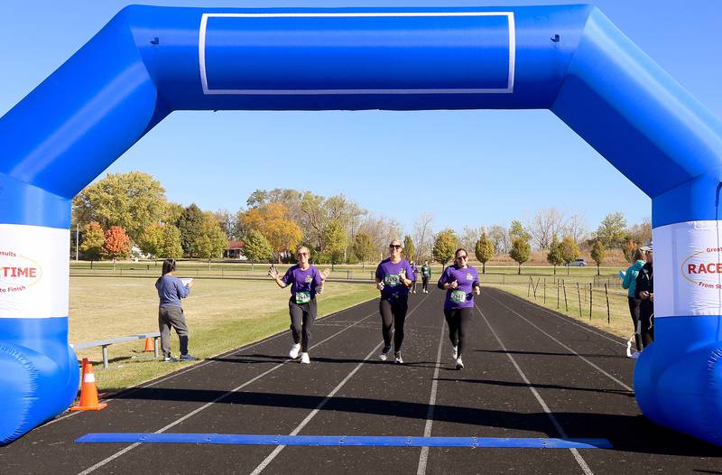 Dede Giffney, Jennifer Brost and Laura Marler near the finish line at the Sugar Grove Park District’s inaugural Run to Remember 5K & Fun Run on Saturday, Oct. 19, 2024 in Sugar Grove.