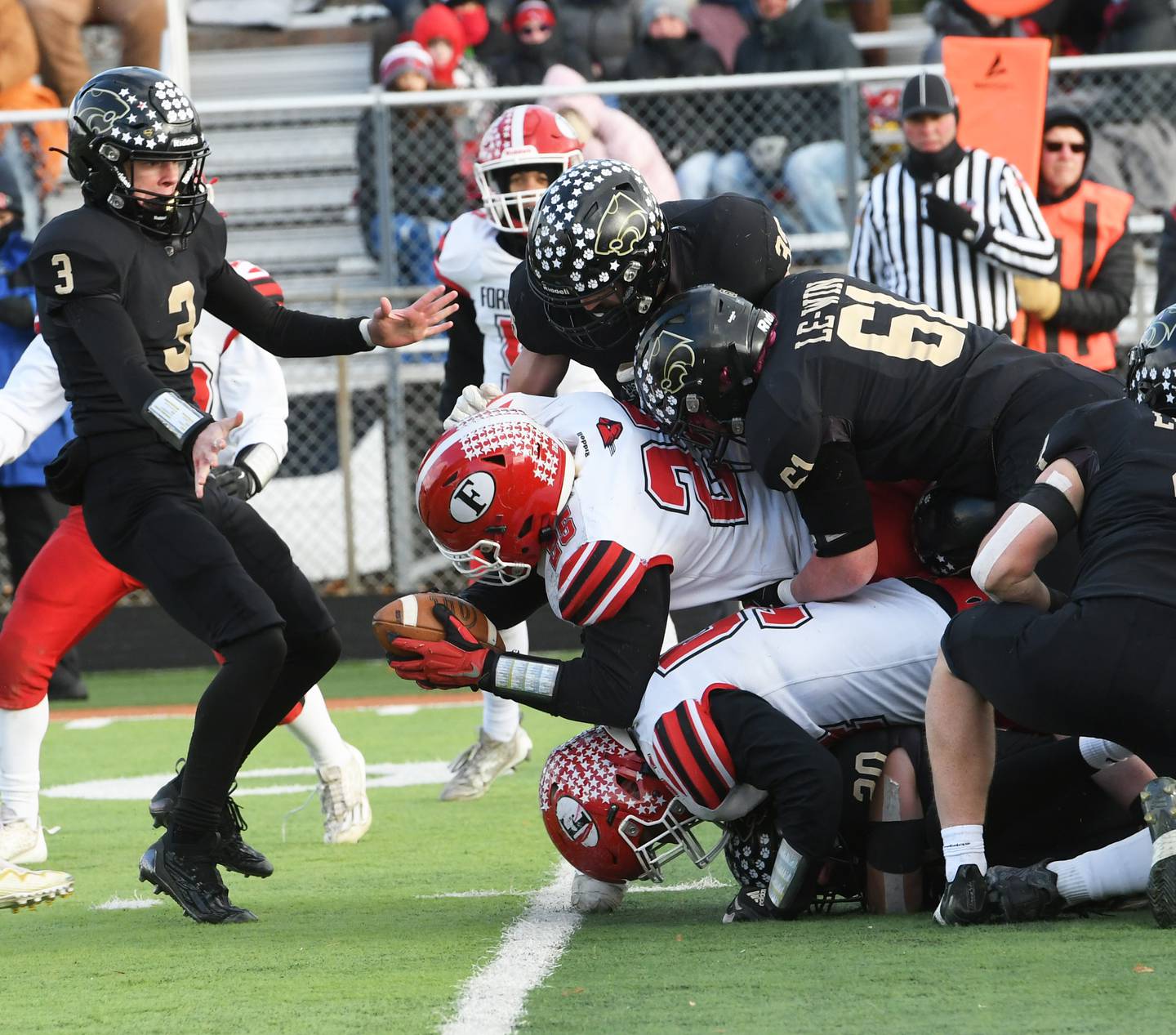 Forreston's Johnathen Kobler fights for yards as Lena-Winslow defenders pile on during first half action at the 1A semifinal in Freeport on Saturday, Nov. 19. The Panthers ended the Cardinals season willing the game 38-16 to advance to the state championship game next Friday in Champaign.