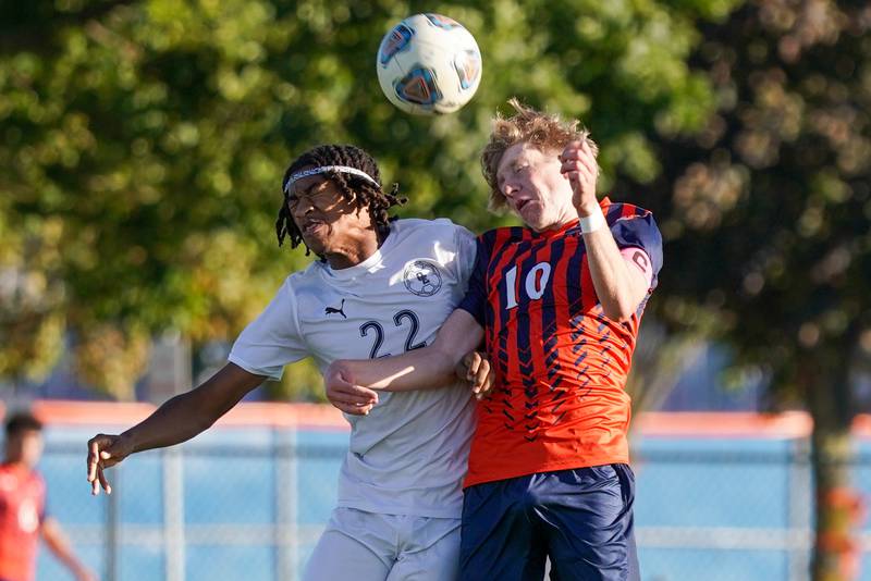 Oswego East's Marlin Hoffman (22) and Oswego’s Alan Mindock (10) go up for a header during a soccer match at Oswego High School on Tuesday, Oct. 1, 2024.