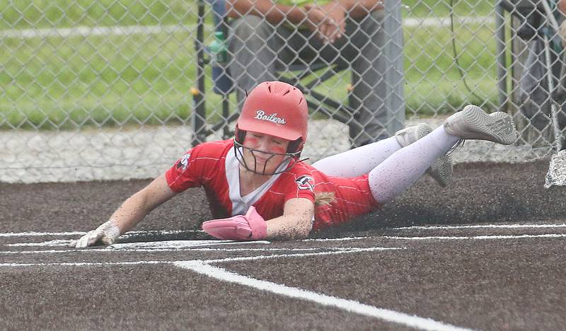 Bradley-Bourbonnais's Shannon Lee scores the teams 6th run after sliding across home plate during the Class 4A Supersectional game on Friday, June 6, 2025 at Monticello High School.