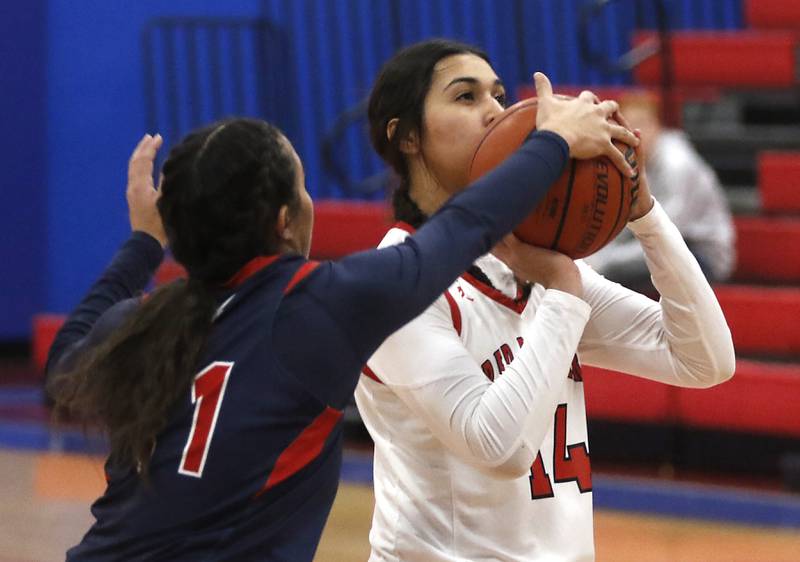 South Elgin’s Addison Tinerella blocks the shot of Huntley’s Yasmine Morsy on Tuesday, Nov. 21, 2023, during a basketball game in the Dundee-Crown High School Girls Thanksgiving Tournament in Carpentersville.