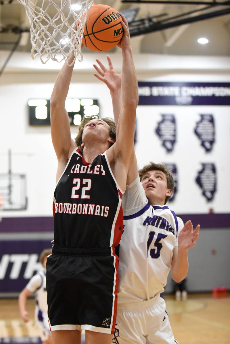 Bradley-Bourbonnais' Tate Marcotte, left, grabs a rebound over Manteno's Colin Saathoff during a game at Manteno Saturday, Dec. 6, 2025.