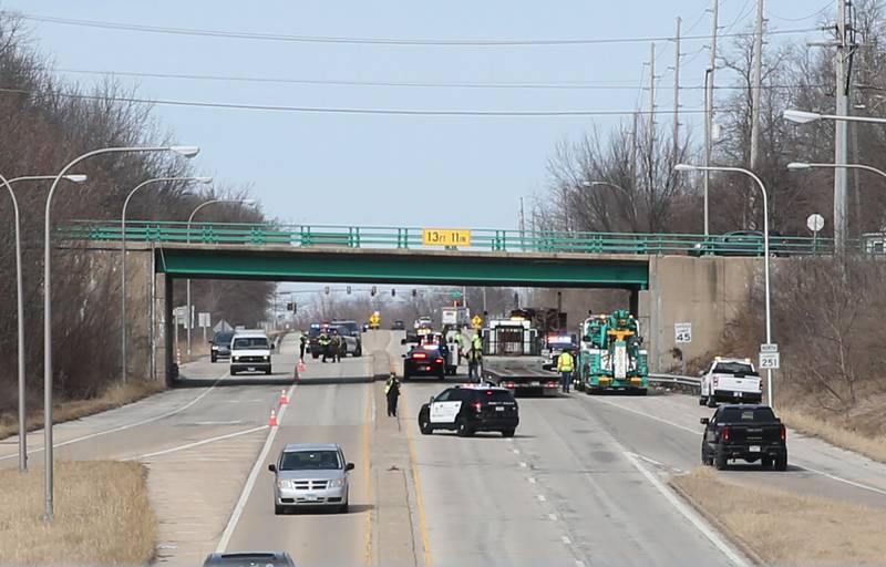 Crews work the scene of a semi that struck the 7th Street bridge over Illinois Route 251 on Monday, March 10, 2025 in Peru. The semi was hauling two clamshell bucket for excavating equipment.
