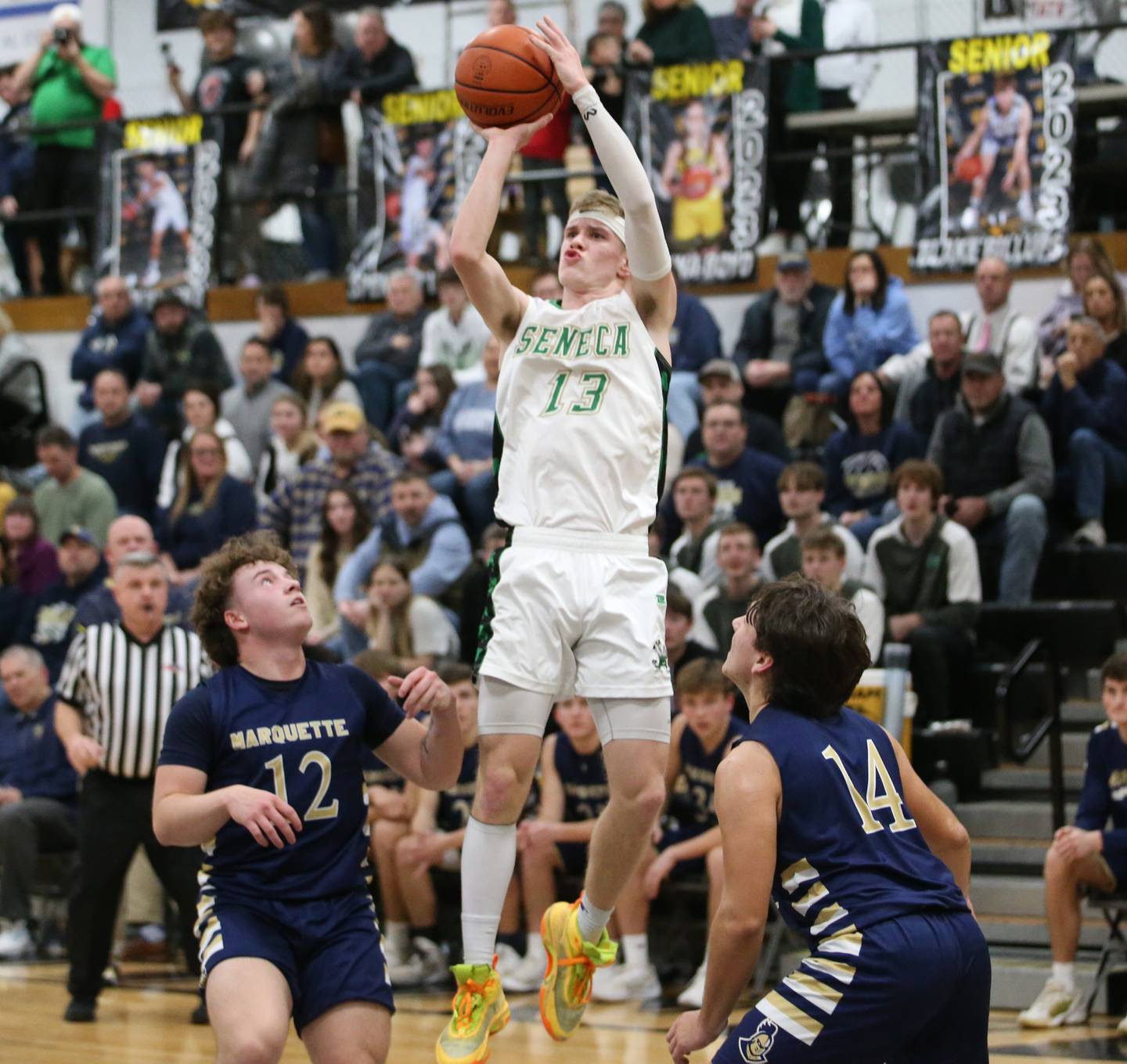 Seneca's Paxton Giertz shoots a jump shot over Marquette's Krew Bond and Alex Graham during the Tri-County Conference championship game on Friday, Jan. 27, 2023 at Putnam County High School.