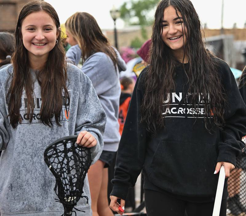 The Crystal Lake Central H.S. girls field hockey team seen celebrating in downtown Crystal Lake during the school's 100 year anniversary homecoming day parade on a rainy Saturday, Sep. 16, 2023 in Crystal Lake. The parade began at the high school and made its way through downtown Crystal Lake.
