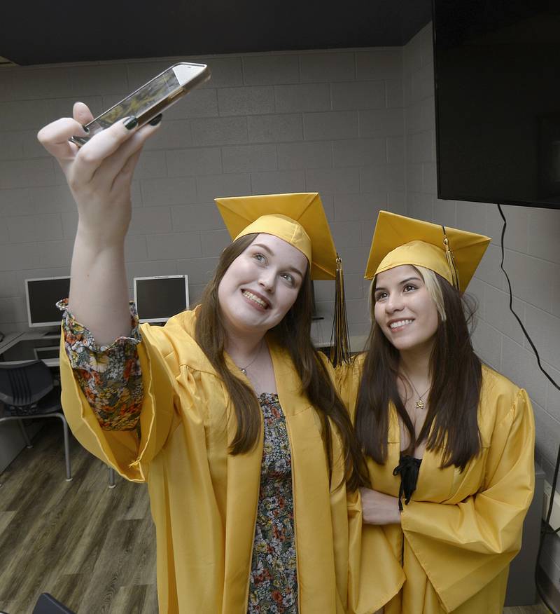Marquette Academy graduates Leanna Sauvageau and Lily Gerkitz capture a photo moment prior to graduation ceremony Sunday, May 28, 2023, at Gould Stadium.