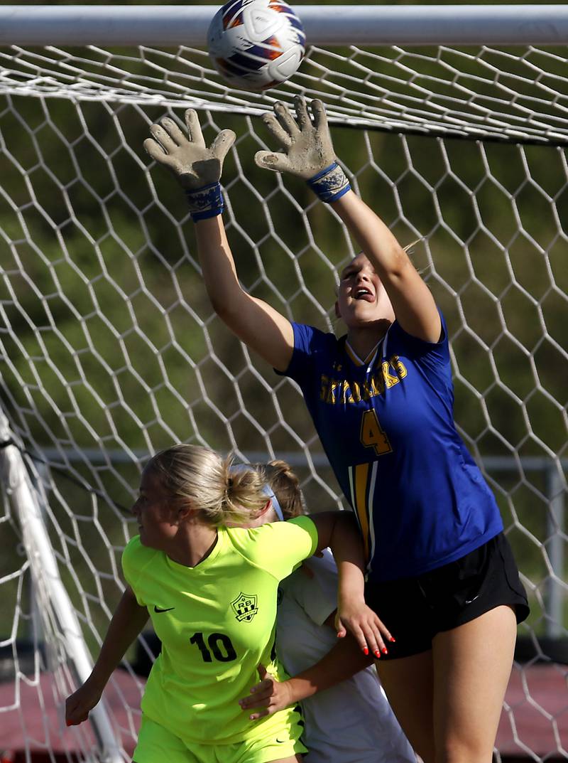 Johnsburg goalie Sophie Person knocks the ball away from Richmond-Burton's Maddie Seyller during the Kishwaukee River Conference Girls Soccer Tournament Championship Match on Wednesday, May 1, 2024, at Richmond-Burton High School.