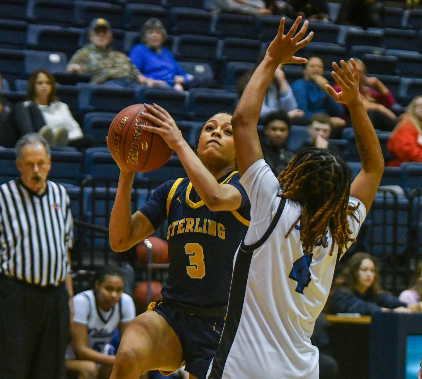 Sterling’s Delali Amankwa puts up a shot over Davenport North’s Damia Clark during the IHMVCU Shootout at the Carver Center in Rock Island