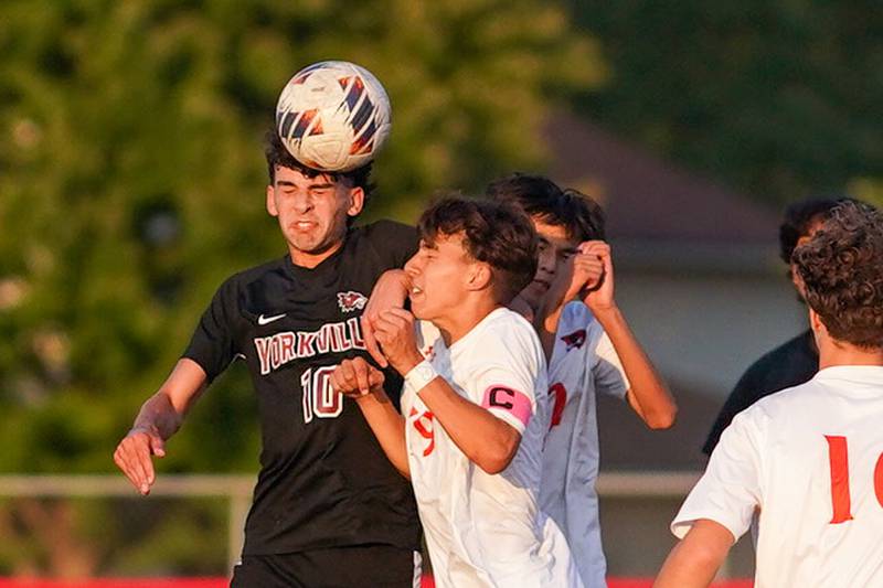 Yorkville's Lukas Kleronomos (10) scores a game tying goal late in the second half off a header against Oswego during a soccer match at Yorkville High School.