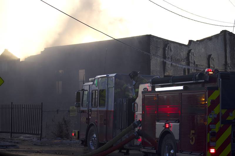 Joliet firefighters at the scene of a fire at an old commercial building on Thursday, Jan. 29, 2026, at the corner of South Eastern Avenue and Washington Street in Joliet.