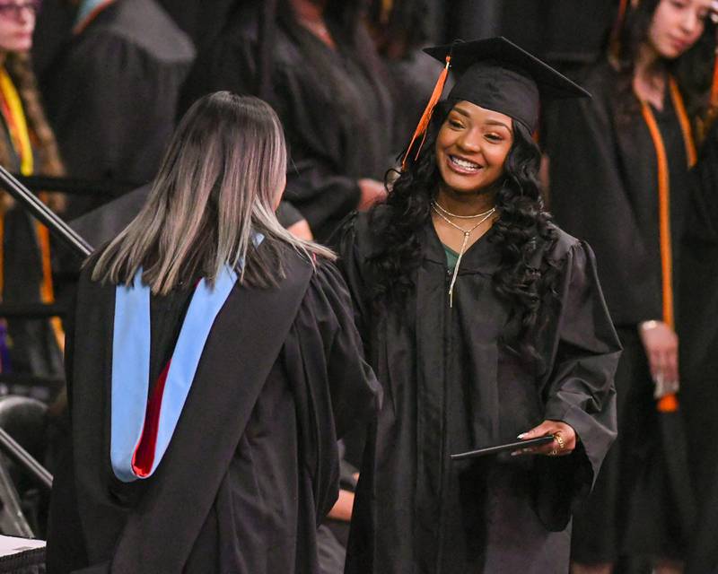 DeKalb High School senior Niajah Marcheill Doby Hughes is all smiles as she accepts her diploma during the Class of 2023 Commencement ceremony at Northern Illinois University's Convocation Center, 1525 W. Lincoln Highway in DeKalb Saturday, May 27, 2023.