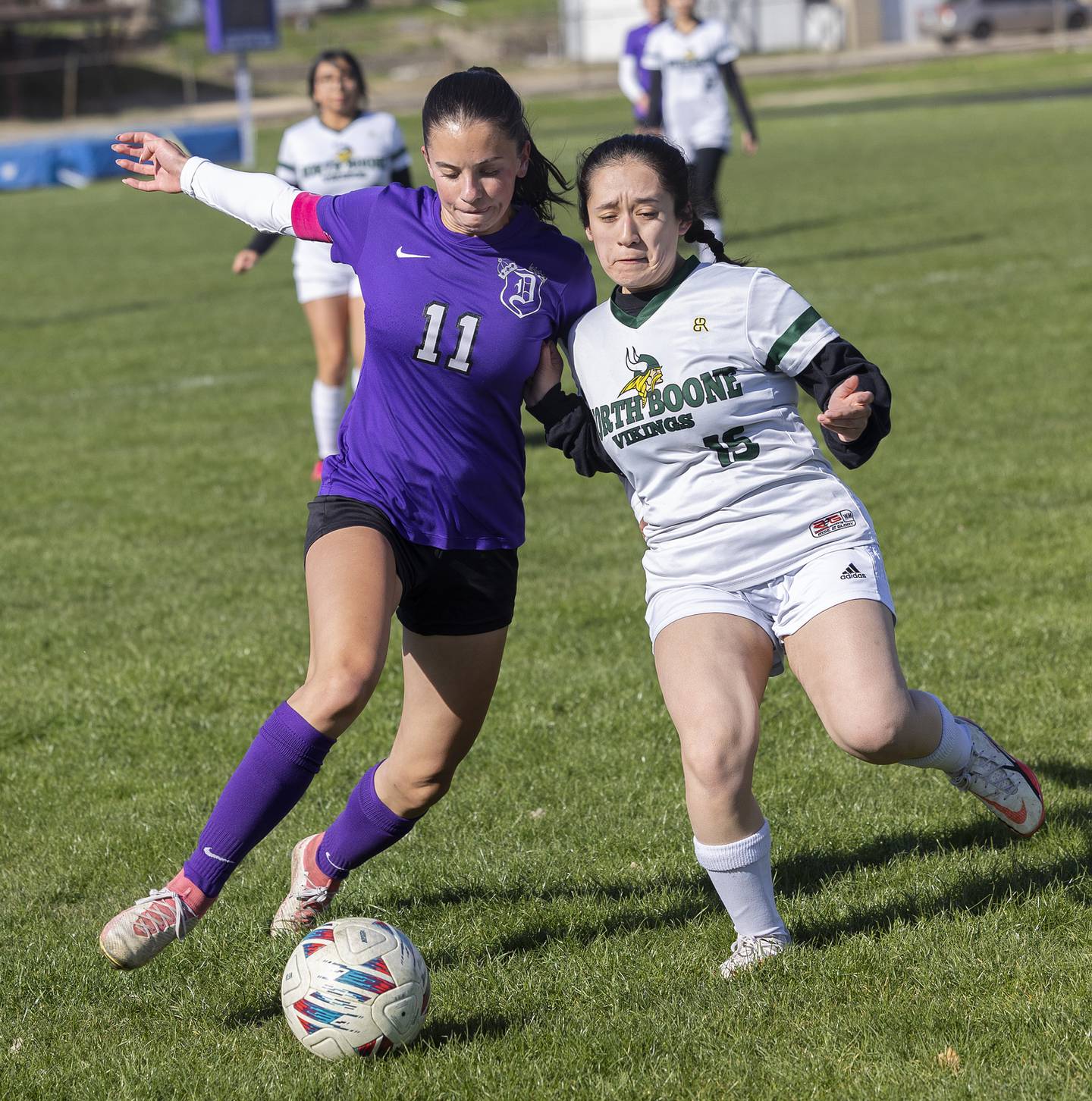 Dixon’s Leah Stees works against North Boone’ Abigail Bolanos Tuesday, April 15, 2025.