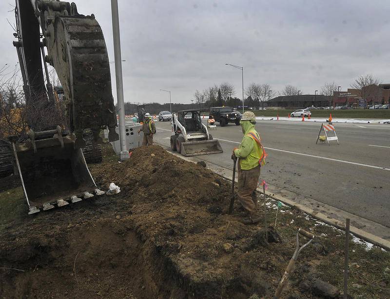 Construction crews work to move utilities Friday, Nov. 16, 2018, along Randall Road just north of Harnish Drive in Algonquin.