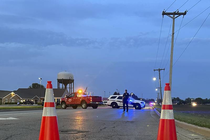 Police block a road leading to a building where a car smashed through during an after-school program, killing several people and injuring others, Monday, April 28, 2025, in Chatham, Ill. (AP Photo/John O'Connor)