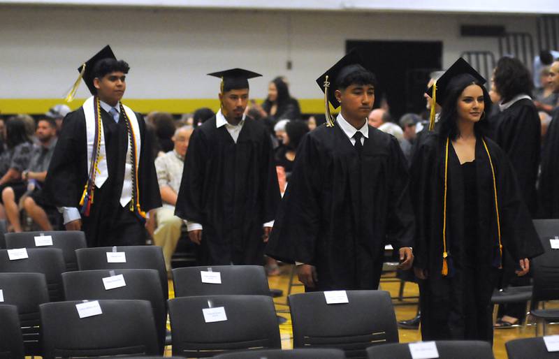 Graduates walks onto the gym Sunday, May 22, 2022, during the Harvard High School Commencement Ceremony in Harvard .