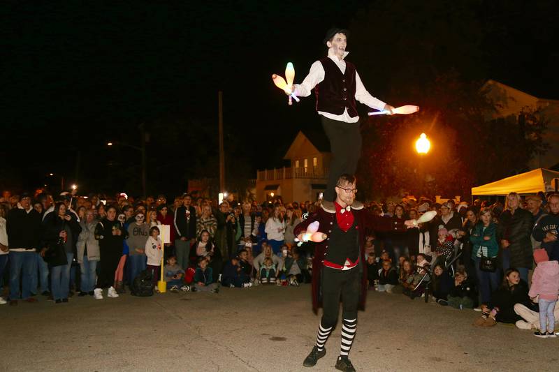 Jugglers Josh Schilling (top) and Austen Cloud (bottom) entertain the huge crowd at the Sixth Annual Thriller on 38 on Friday, Oct. 20, 2023 in Geneva.