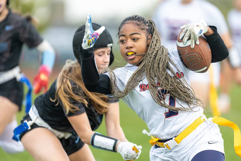 West Aurora's Aiyanah Sylvester carries the ball as Willowbrooks McKenzie Edison pulls the flag during play at the Sectional Final on Tuesday, Oct. 14,2025 in South Elgin.
