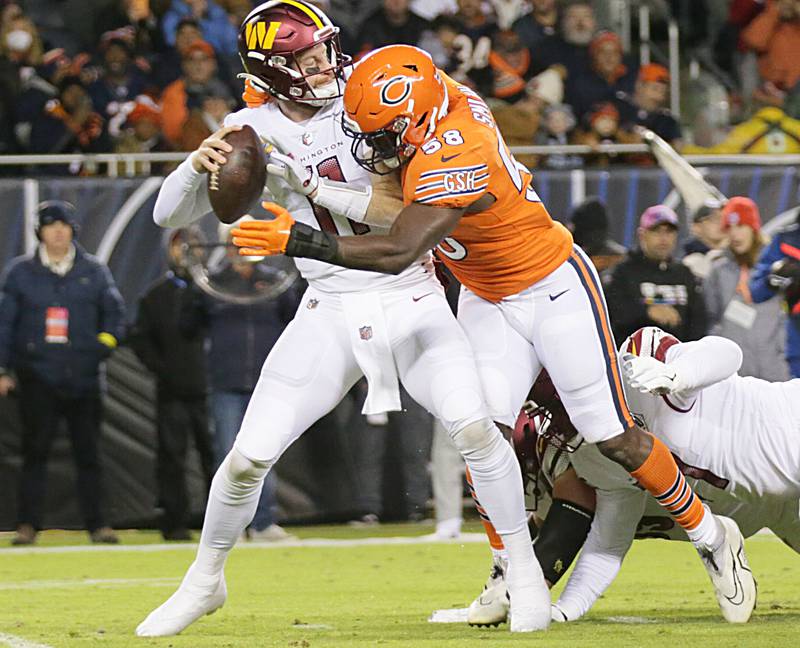 Washington Commanders quarterback Carson Wentz is sacked by Chicago Bears linebacker Roquan Smith (58) on Thursday, Oct. 13, 2022 at Soldier Field.