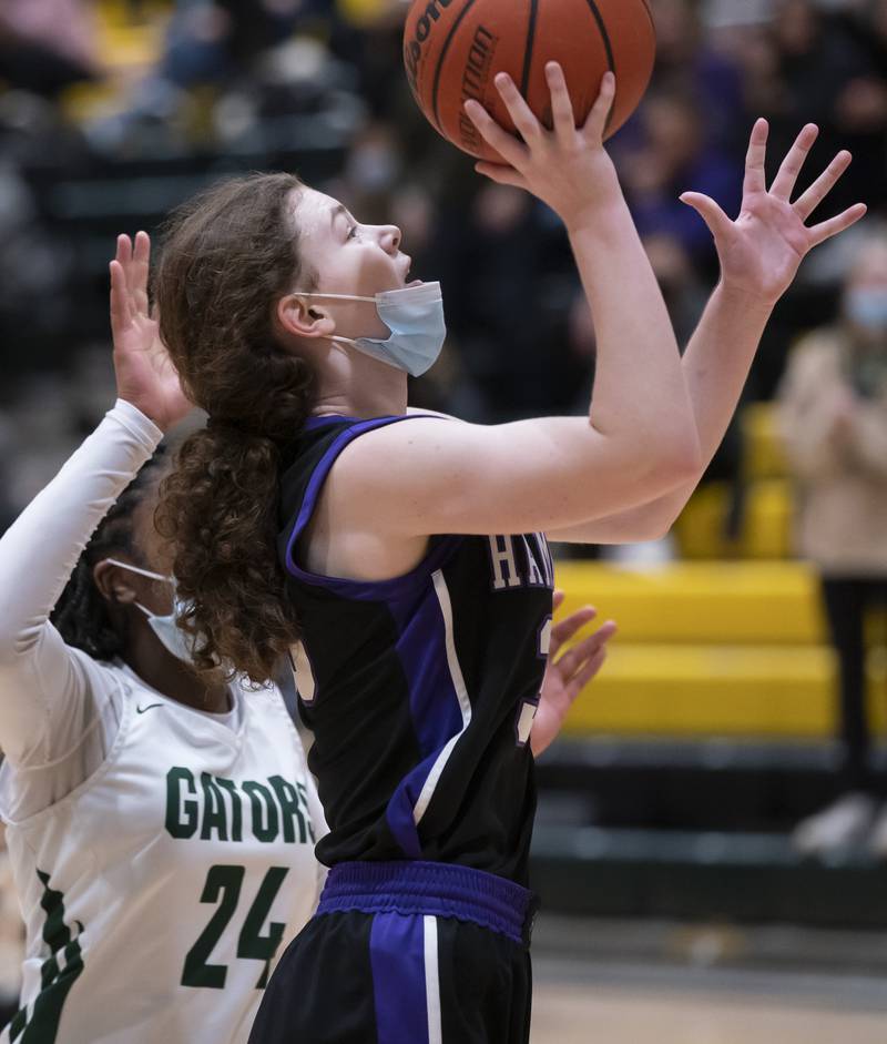 Hampshire's Ashley Herzing shoots a basket as Crystal Lake South's Kree Nunnally defends during their game on Friday, January 14, 2022 at Crystal Lake South High School.