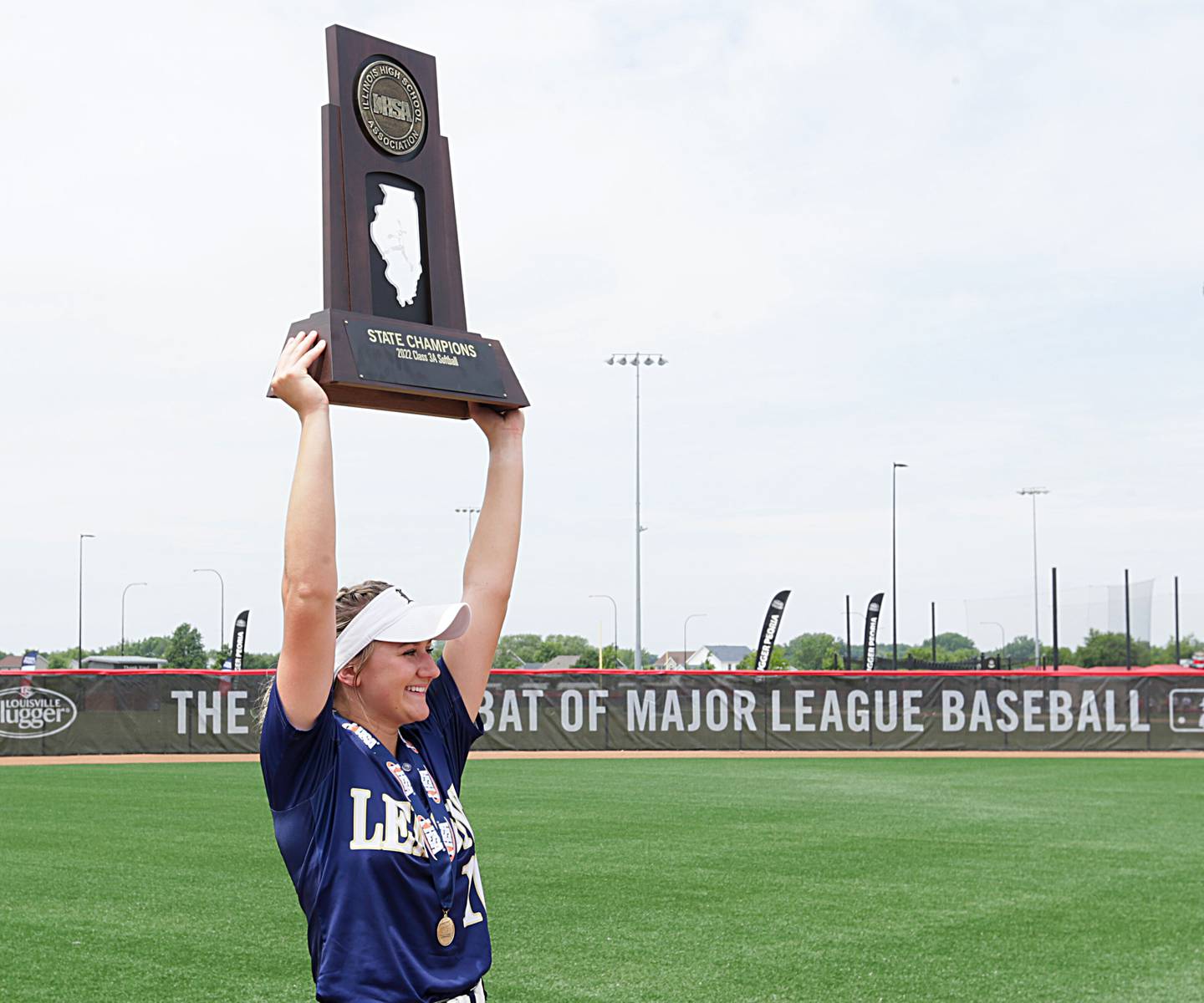 Lemont pitcher Sage Mardjetko hoists the Class 3A trophy in the air after winning the State Championship on Saturday, June 11, 2022 at Louisville Slugger Sports Complex in Peoria. Mardjetko pitched a no-hitter against St. Ignatius College Prep to win the state championship.