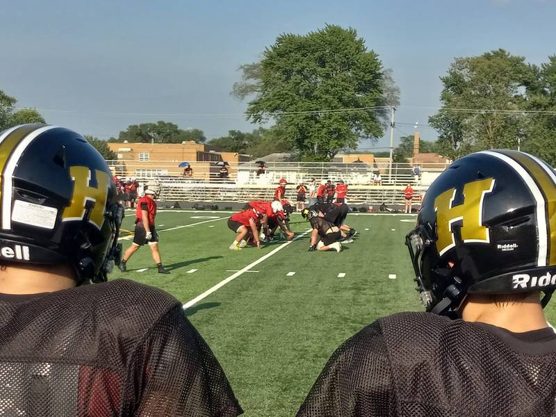 The Herscher sideline looks on as Herscher's defense faces Bradley-Bourbonnais' offense in an 11 on 11 scrimmage at Herscher High School on July 22, 2025.