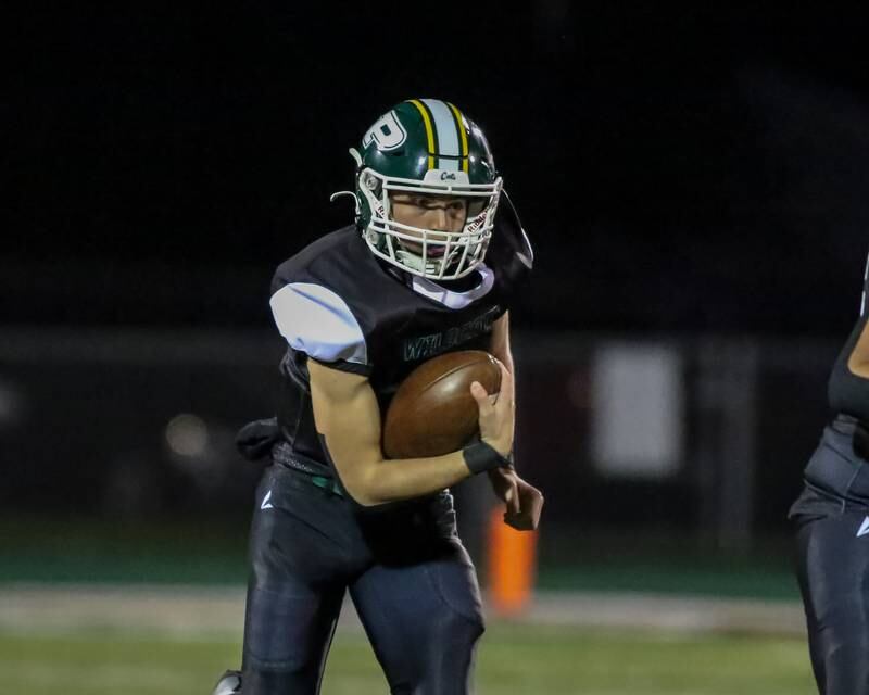 Plainfield Central's Matt Leto (7) runs a keeper up the middle during football game between Joliet West at Plainfield Central.   Oct 20, 2023.