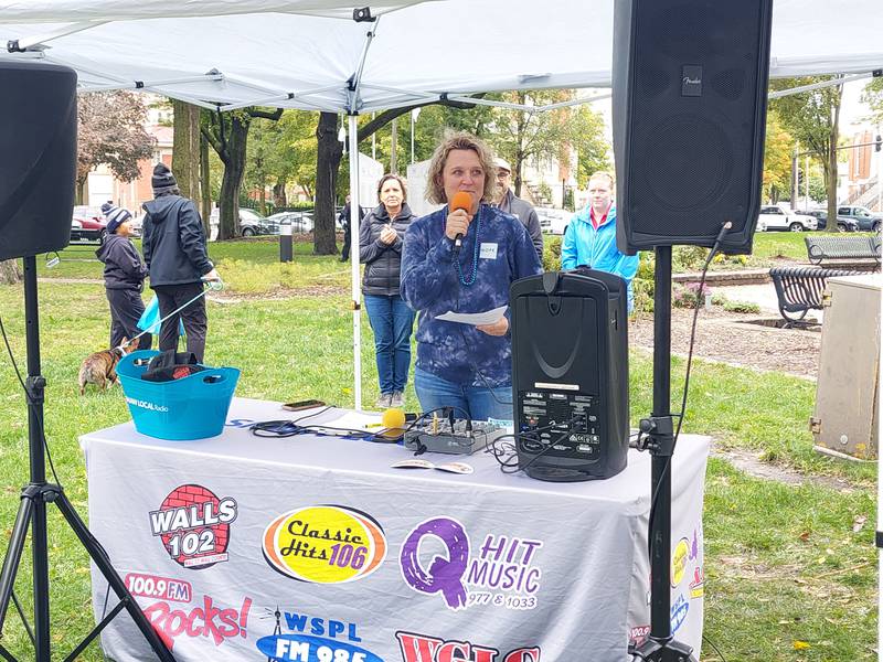 Sarah Scruggs, of the Arukah Institute, talks Saturday, Oct. 14, 2023, about the new Living Room center that recently opened in Ottawa during the Out of the Darkness Walk at Washington Square.