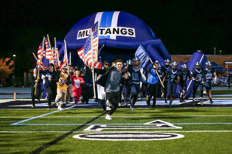 Downers Grove South runs out on the field before their Class 8A Playoff football game between Plainfield South at Downers Grove South on Friday, Nov 1, 2024  in Downers Grove.