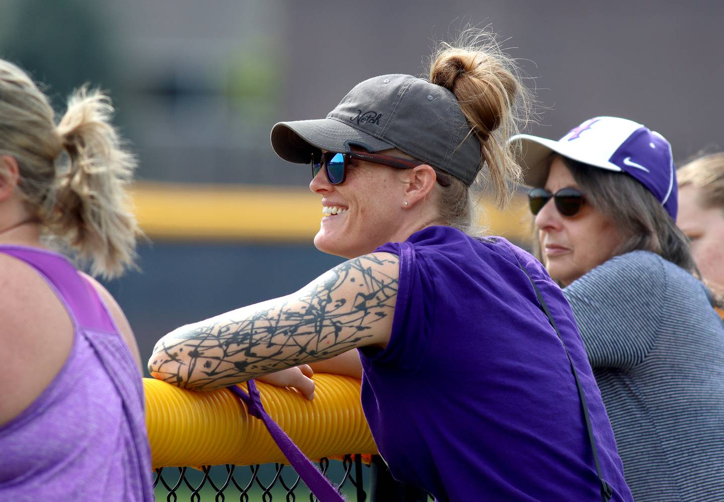 Molly Fivelson wetches as her husband Derek coaches the  Conant team against her son Ari’s  Hampshire team  in varsity baseball at Hoffman Estates Saturday.