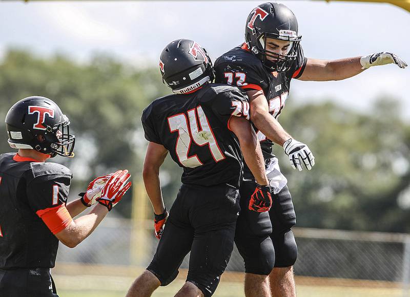 Crystal Lake Central's Alan Pawlicki and Ryan Williams celebrate after Williams scored a touchdown during the first quarter of Saturday's makeup game against Grant at Crystal Lake South HIgh School August 30, 2014. Crystal Lake Central won, 42-6.