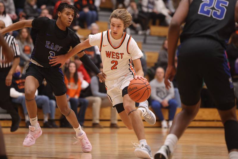 Lincoln-Way West’s Eli Bach drives to the paint against Lincoln-Way East.