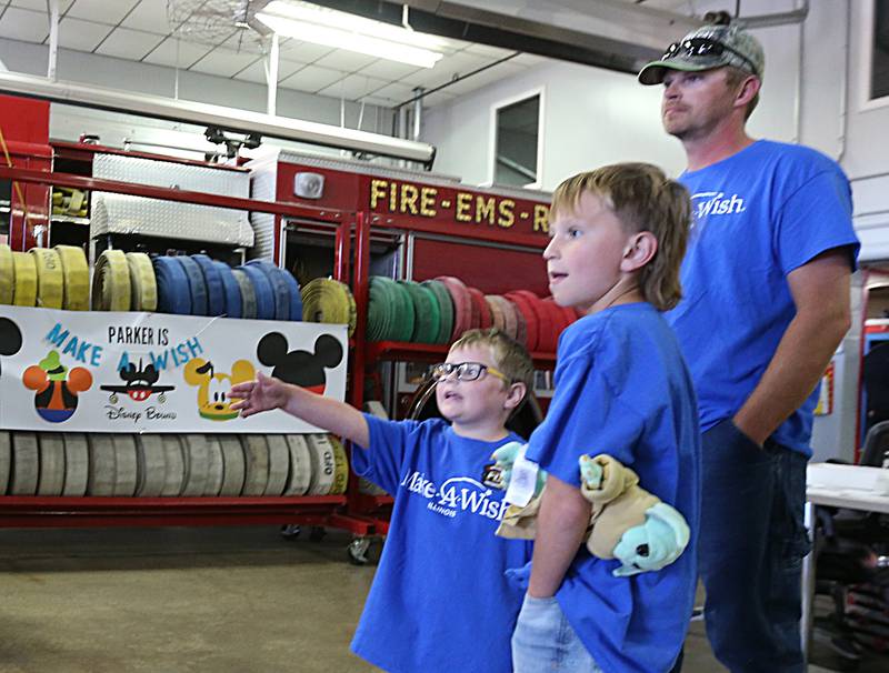 Parker Vangalder 6, of Seneca, points to a fire truck with his brother Colton and father Brian on Monday, Oct. 10, 2022. Vangelder and his family are going to Walt Disney World later this month courtesy of Make-A-Wish.