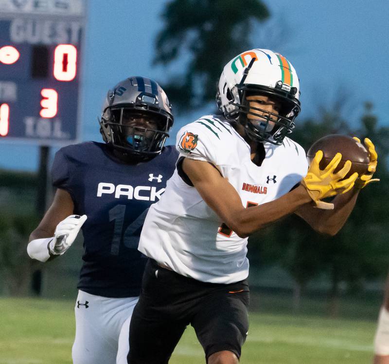 Plainfield East's Quinn Morris (1) makes a catch against Oswego East's JaMarcus Garrett (14) during a football game at Oswego East High School in Oswego on Friday, Sep 10, 2021.