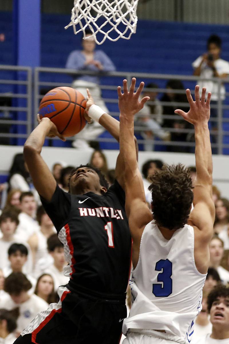Huntley's Bryce Walker drives to the basket against Burlington Central's Lucas Kerr during a Fox Valley Conference boys basketball game on Friday, Dec. 15, 2023, at Burlington Central High School.