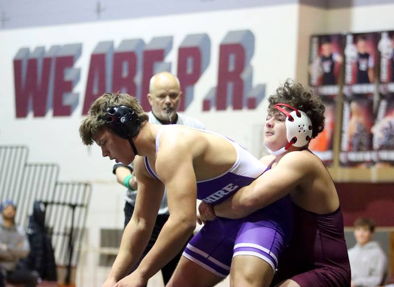 Prairie Ridge’s Frank Matviychuk, right, battles Hampshire’s Knox Homola at 215 pounds in varsity boys wrestling on Thursday, Dec. 4, 2025, at  Prairie Ridge High School in Crystal Lake.