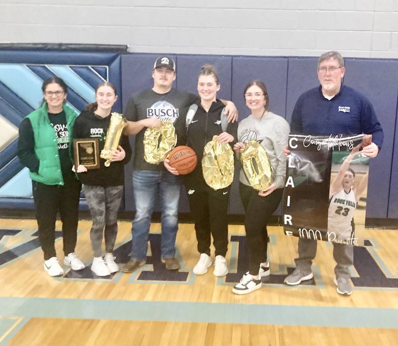 Rock Falls senior Claire Bickett is joined by her family celebrating scoring her 1,000-career point in the Rockets' 59-47 win in regional quarterfinal play at Bureau Valley on Saturday night.