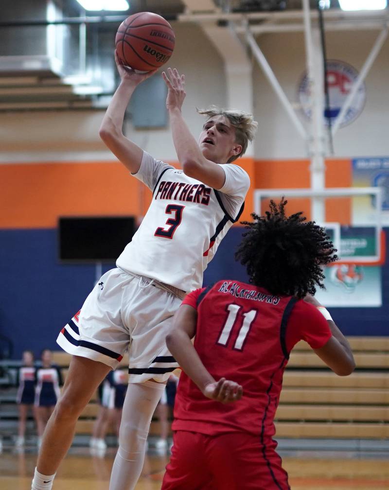 Oswego’s Nolan Petry (3) shoots a floater over West Aurora's Jordan Brooks (11) during a basketball game at Oswego High School on Friday, Dec 1, 2023.