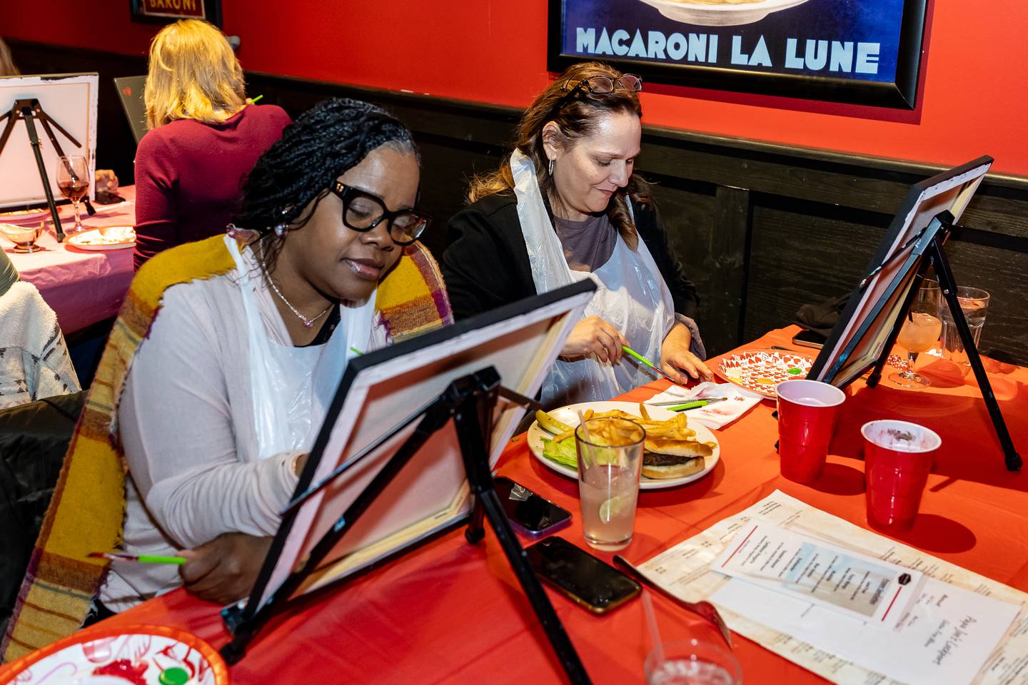 Dolton resident Angelia Lee and Kristine Czaplicki, of Lockport, enjoy Divine Design Paint Studio's paint party at Papa Joe's in Lockport on Feb. 6, 2025.
