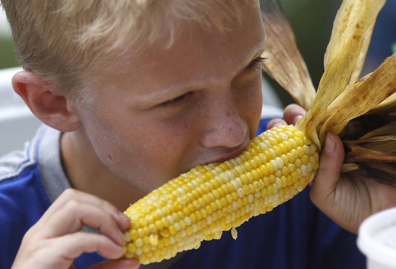 Max Jaeger, 9, enjoys an ear of corn during Lakeside Festival on Friday, July 5, 2024, at the Dole.