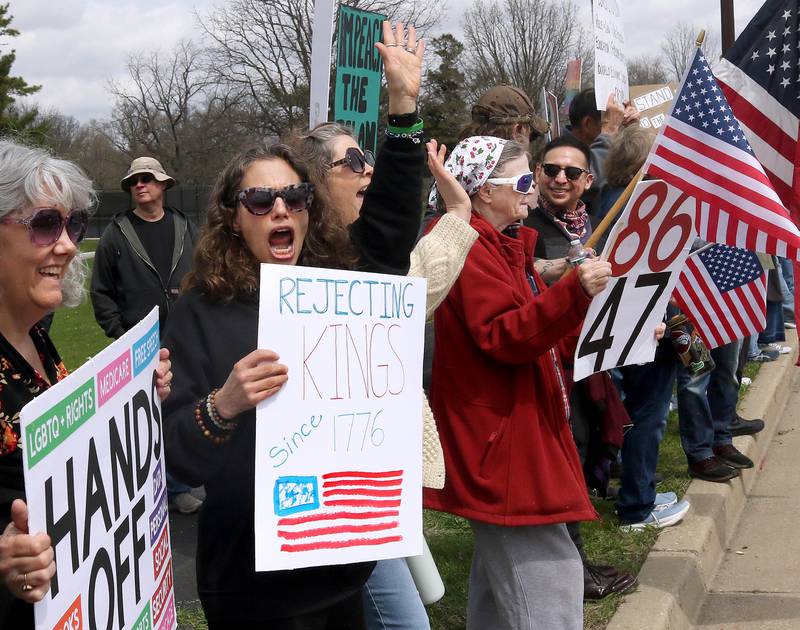 Protesters cheer as cars honk their horns along Sycamore Road Saturday, April 19, 2025, during a “No Kings” rally and march at Hopkins Park in DeKalb. The group was protesting what they’ve argued is the unlawful and harmful federal policies of President Donald Trump and his administration.