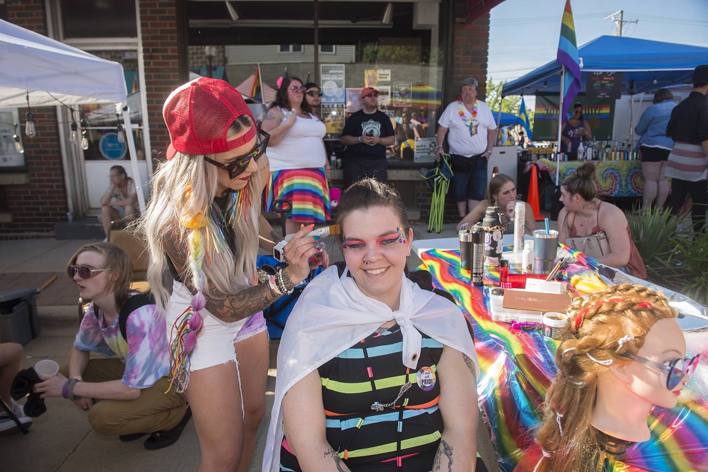 Maggie Love gives Raven Kay of Prophetstown some extra flash Saturday, June 18, 2022 at Dixon’s Pride Fest. Fusion Salon in downtown Dixon was on hand to offer customers some fun hair and makeup options.