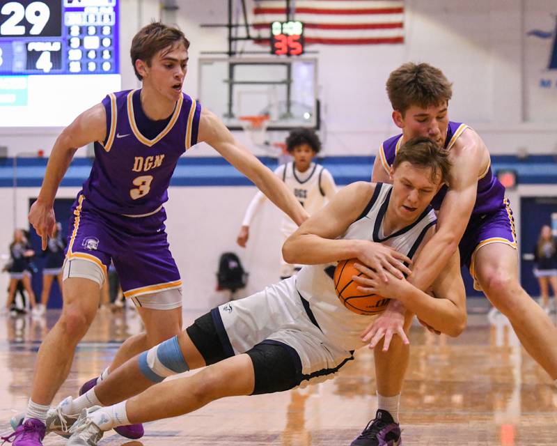 Downers Grove South's Daniel Sveiteris (25) fights for the ball while being defended by Downers Grove North's Bobby Grganto (10) during the game on Saturday Dec. 21, 2024, held at Downers Grove South High School.