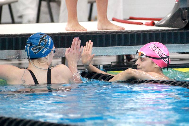 Plainfield’s Mia Ceballos (right) congratulates St. Charles North’s Jenna Williams following the 100-yard backstroke consolation heat during the IHSA Girls State Swimming and Diving Championships at the FMC Natatorium in Westmont on Saturday, Nov. 11, 2023.