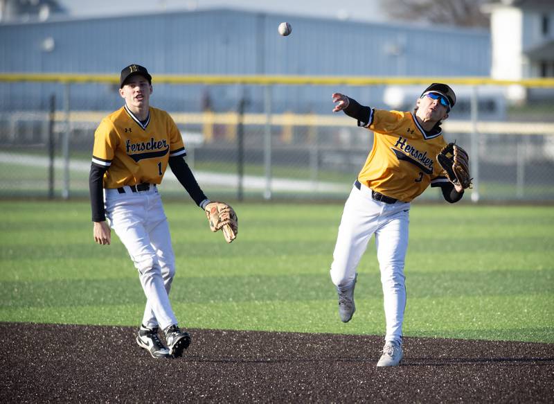 Herscher's Alec Nicholos fields a ground ball and throws on to first for an out in the fourth inning of the game against Central on April 11, 2025. To the left is Mason Roberts.