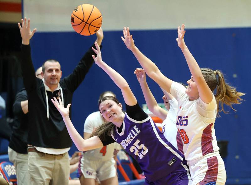 Genoa-Kingston's Arielle Rich knocks the ball away from Rochelle's Jaydin Dickey in front of Genoa-Kingston coach Doug Brewington during their game Monday, Dec. 16, 2024, at Genoa-Kingston High School.