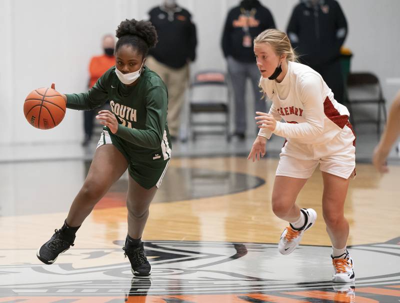 Crystal Lake South's Kree Nunnally looks to get past McHenry's Emerson Gasmann during their game on Tuesday, January 11, 2022 in McHenry.